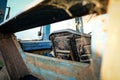 Old farm tractor seat seen from the rear of the opened cab. Royalty Free Stock Photo