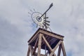 Old farm windmill with metal blades Royalty Free Stock Photo