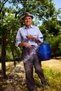 Old farmer fertilizing in an orchard Royalty Free Stock Photo