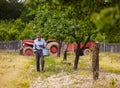 Old farmer fertilizing in an orchard Royalty Free Stock Photo