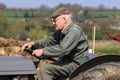 Old farmer on grey massey fergusen tractor at ploughing match