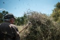 Old farmer making a haystack with a pitchfork for the winter on a sunny day in autumn. Agricultural work. Hay harvesting Royalty Free Stock Photo