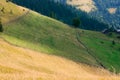 An old farmer's wooden house stands on an elephant mountain near a haystack against the backdrop of mountain peaks Royalty Free Stock Photo