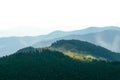 An old farmer's wooden house stands on an elephant mountain near a haystack against the backdrop of mountain peaks Royalty Free Stock Photo