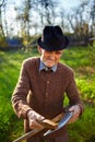 Old farmer sharpening scythe Royalty Free Stock Photo