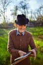 Old farmer sharpening scythe Royalty Free Stock Photo