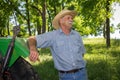 Old Farmer Stands by Tractor Royalty Free Stock Photo