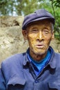 Old farmer in traditional blue