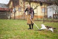 Old farmer woman cleaning with a rake Royalty Free Stock Photo