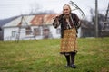 Old farmer woman cleaning with a rake Royalty Free Stock Photo