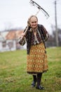 Old farmer woman cleaning with a rake Royalty Free Stock Photo