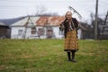 Old farmer woman cleaning with a rake Royalty Free Stock Photo