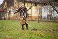 Old farmer woman cleaning with a rake Royalty Free Stock Photo