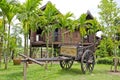 Old farmer wooden cart and Thai house style. Royalty Free Stock Photo