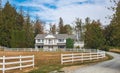 Typical North American Country Farm House on sunny day. Farm yard with the plowed field in front Royalty Free Stock Photo