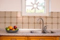 Old Farmhouse Kitchen Sink and Faucet vintage design with pattern tiles and cozy window