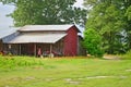 Old Farming Equipment, Tractor, and Red Barn Royalty Free Stock Photo