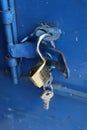 Old-fashion padlock in a blue metal door Royalty Free Stock Photo