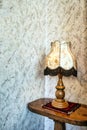 Old fashion table lamp near vintage stylish wallpaper with copy space, antique design Royalty Free Stock Photo