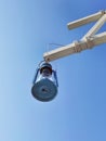 Old fashioned antique blue color oil or gas lamp or lantern hanging off the wooden beam against blue sky, metal retro light Royalty Free Stock Photo