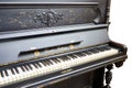 Old-fashioned antique ornamental piano with carved pillars. After restoration