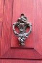 Old fashioned antique red door with knocking