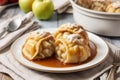 Old fashioned apple dumplings on a white plate