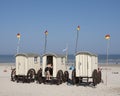 Old fashioned bathing carts used for changing on sunny beach of german island norderney