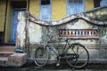 Old fashioned bicycle left by crumbling wall