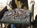 Old-fashioned blacksmith furnace with burning coals for iron work Royalty Free Stock Photo