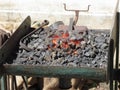 Old-fashioned blacksmith furnace with burning coals for iron work Royalty Free Stock Photo