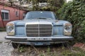 Old fashioned blue German Mercedes, rusting in the garden