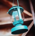 Old-fashioned blue lantern. Wooden background.