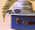 Old fashioned blue suitcase for travel and beach hat Royalty Free Stock Photo