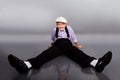 Old fashioned boy sitting on gray background Royalty Free Stock Photo