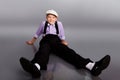 Old fashioned boy sitting on gray background Royalty Free Stock Photo