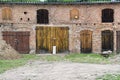 Old brick-built commercial building with closes wooden doors Royalty Free Stock Photo