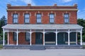 Old fashioned brick building with full width front porch