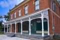 Old fashioned brick building with full width front porch