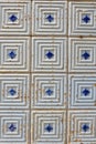 Old-fashioned broken, weathered and dirty tiles in Portugal. Vertical photo