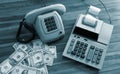 Old fashioned calculator, telephone and dollars Royalty Free Stock Photo