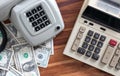Old fashioned calculator  telephone and dollars Royalty Free Stock Photo
