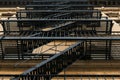 Old-fashioned cast-iron fire-escape on the outside of an apartment building in New York City`s Harlem neighborhood, NYC Royalty Free Stock Photo