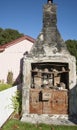 Old-fashioned cast iron stove in remains of house chimney