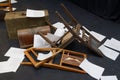 Old-fashioned chairs, chests and pieces of paper put in a mess on a theatre stage Royalty Free Stock Photo