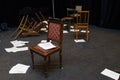 Old-fashioned chairs, chests and pieces of paper put in a mess on a theatre stage Royalty Free Stock Photo