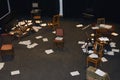 Old-fashioned chairs, chests and pieces of paper put in a mess on a theatre stage Royalty Free Stock Photo