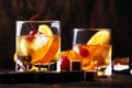 Old Fashioned - classic alcoholic cocktail with bourbon whiskey, bitter, cane sugar and ice in retro glasses on vintage bar Royalty Free Stock Photo