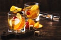 Old fashioned cocktail with bourbon, cane sugar, orange slice, cherry and orange peel garnish, vintage wood table, copy space Royalty Free Stock Photo