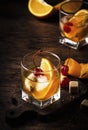 Old fashioned cocktail with bourbon, cane sugar, orange slice, cherry and orange peel garnish, vintage wood table, copy space Royalty Free Stock Photo